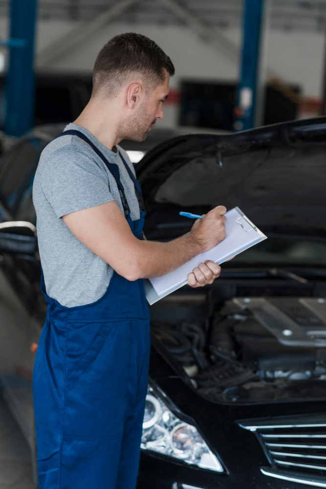 worker-cleaning-modern-vehicle-alloy-wheels